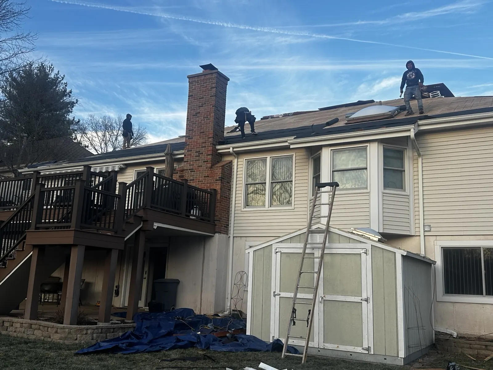 Roofers working near the chimney