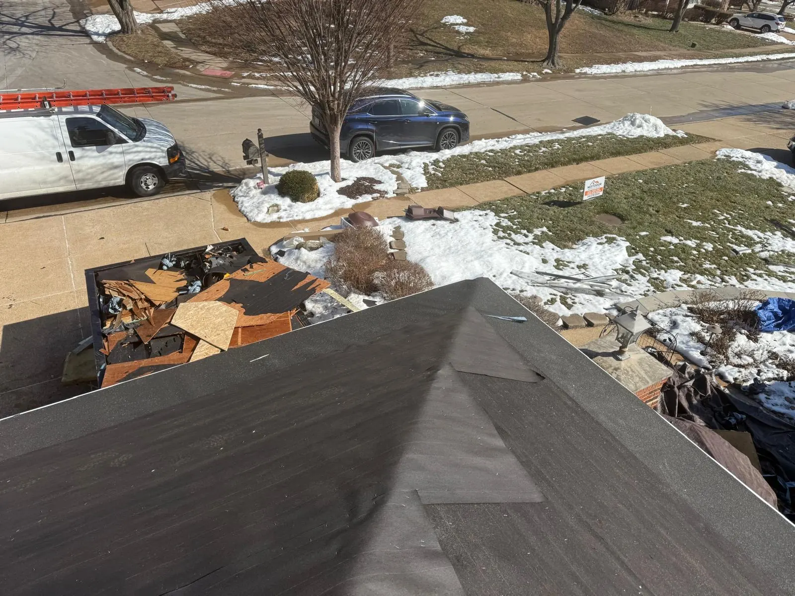 Old shingles torn off and loaded into a dumpster